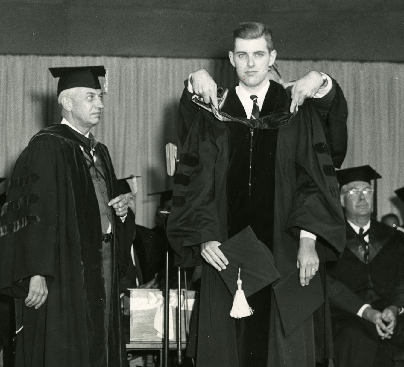 With Caltech president Lee DuBridge looking on, Brooks receives his PhD in 1954. Caltech Archives Photo