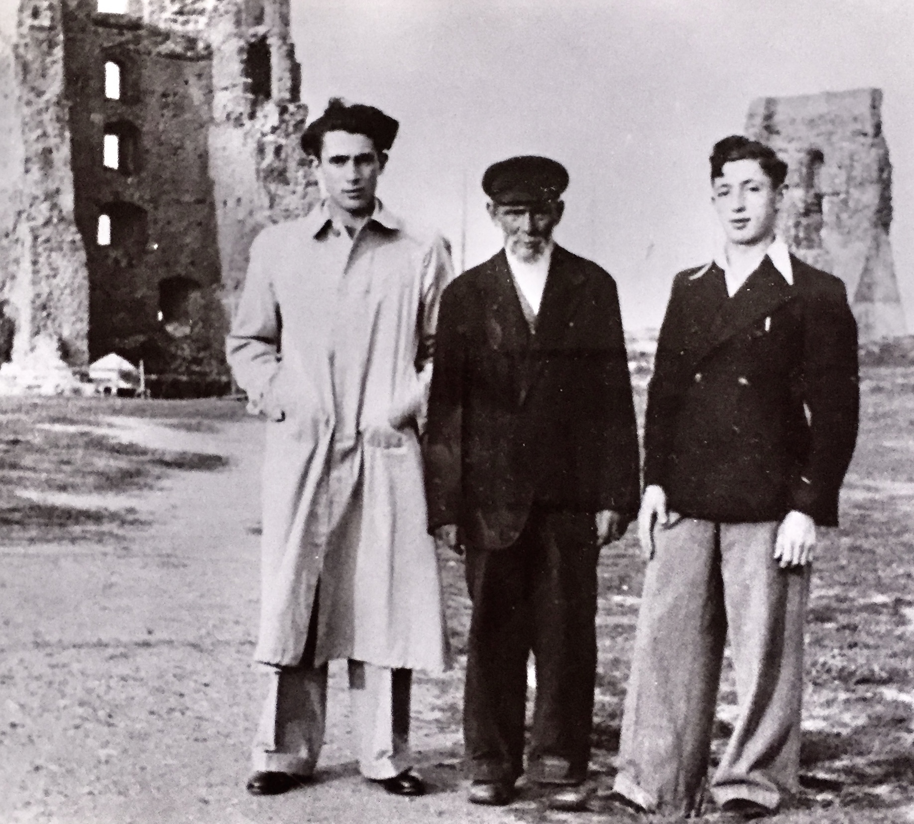 From left, Shuki Bruck’s uncle David, grandfather Shlomo, and father, Moshe Bruk, in 1938, photographed in front of the ruins of the old castle of Nowogródek, which still stands today. Photo courtesy of Shuki Bruck
