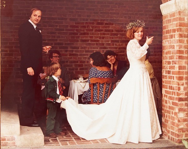 Wedding day, September 1981, with groom Egill Hauksson and train bearer Chris Bilham. Having recently seen Lady Diana’s televised wedding, “when he saw the train on my dress, he latched on and stayed there the whole reception.” Photo courtesy of Lucy Jones
