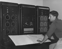 Dan Harris, Caltech’s first PhD in radio astronomy, at the control panels.