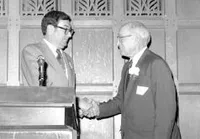Arnold Beckman congratulating Harry Gray on receiving the Tolman Award
