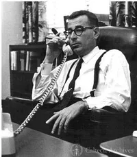 Harold Brown at desk, speaking on phone