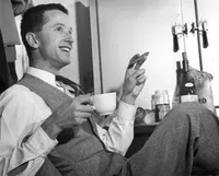 Max Delbruck with cigar and cup of coffee