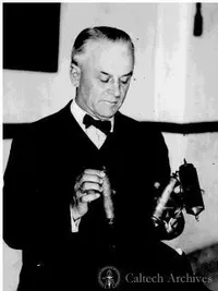 Robert A. Millikan holding 2 C.R. electrometers