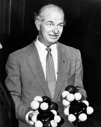 Linus Pauling holding models of molecules