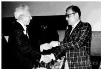 Harold Brown shaking hands with unknown man