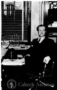 Linus Pauling seated at his desk