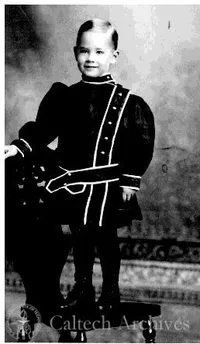 Young George Beadle wearing a dress