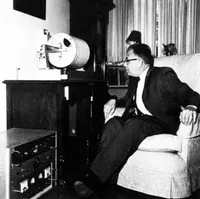 Charles Richter with seismometer that he keeps in the living room of his home