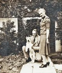 Richard and Ruth Tolman and their dog in front of their home