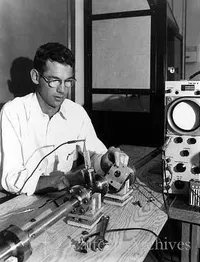 Unidentified man next to an oscilloscope