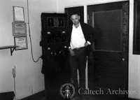 Benjamin Traxler, electrician, with the radio tansmitter used to keep in touch with the Caltech campus