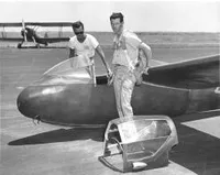 Paul MacCready in soaring gear near a plane