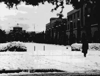 Snow-covered campus with Throop Hall in the background
