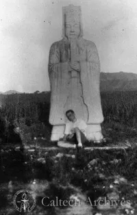 Theodore von Karman in front of a statue in Japan