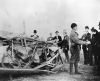 John B. Moisant shaking hands with a friend after his plane was wrecked in a forced landing