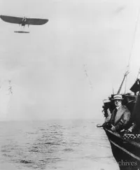 Louis Bieriot flying across the English Channel with a convoy boat in the foreground