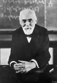 H. A. Lorentz seated before a blackboard