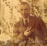 J. Robert Oppenheimer standing with pipe in hand
